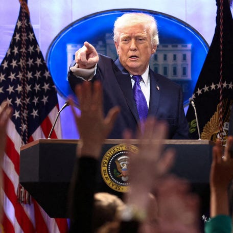 President Donald Trump is pictured answering questions from reporters at the White House.