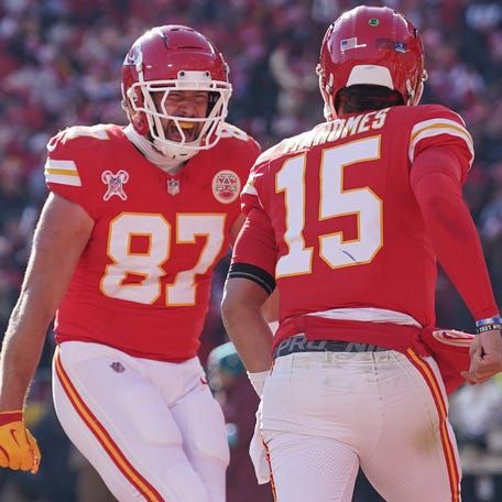 Kansas City Chiefs tight end Travis Kelce (87) celebrates with quarterback Patrick Mahomes (15) after Mahomes' touchdown against the Houston Texans during the first half at GEHA Field at Arrowhead Stadium.