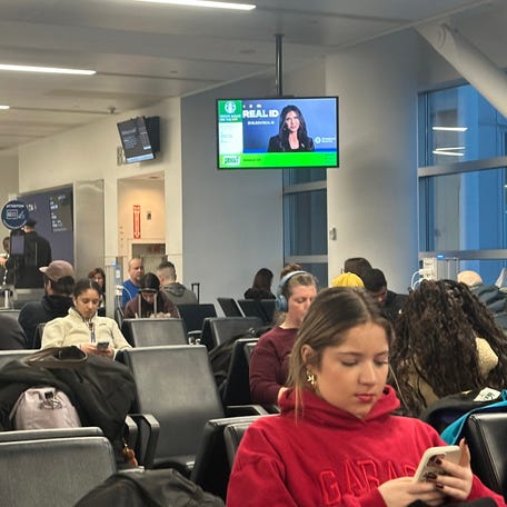 Travelers wait at a gate on Feb. 22, 2026, at John F. Kennedy International Airport in New York City.