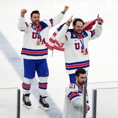 Team USA captain Auston Matthews celebrates with teammates after winning the men's hockey gold medal game.