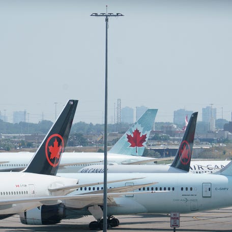 Air Canada airplanes stand on the tarmac at Pearson International Airport in Toronto on August 16, 2025. Air Canada cancelled hundreds of flights Saturday as it began shutting down operations in response to a strike by flight attendants -- triggering summer travel chaos for its 130,000 daily passengers. Canada's largest airline, which flies directly to 180 cities worldwide, urged customers not to go to the airport if they have a ticket for Air Canada or its lower-cost subsidiary Air Canada Rouge.   (Photo by Peter POWER / AFP) (Photo by PETER POWER/AFP via Getty Images)