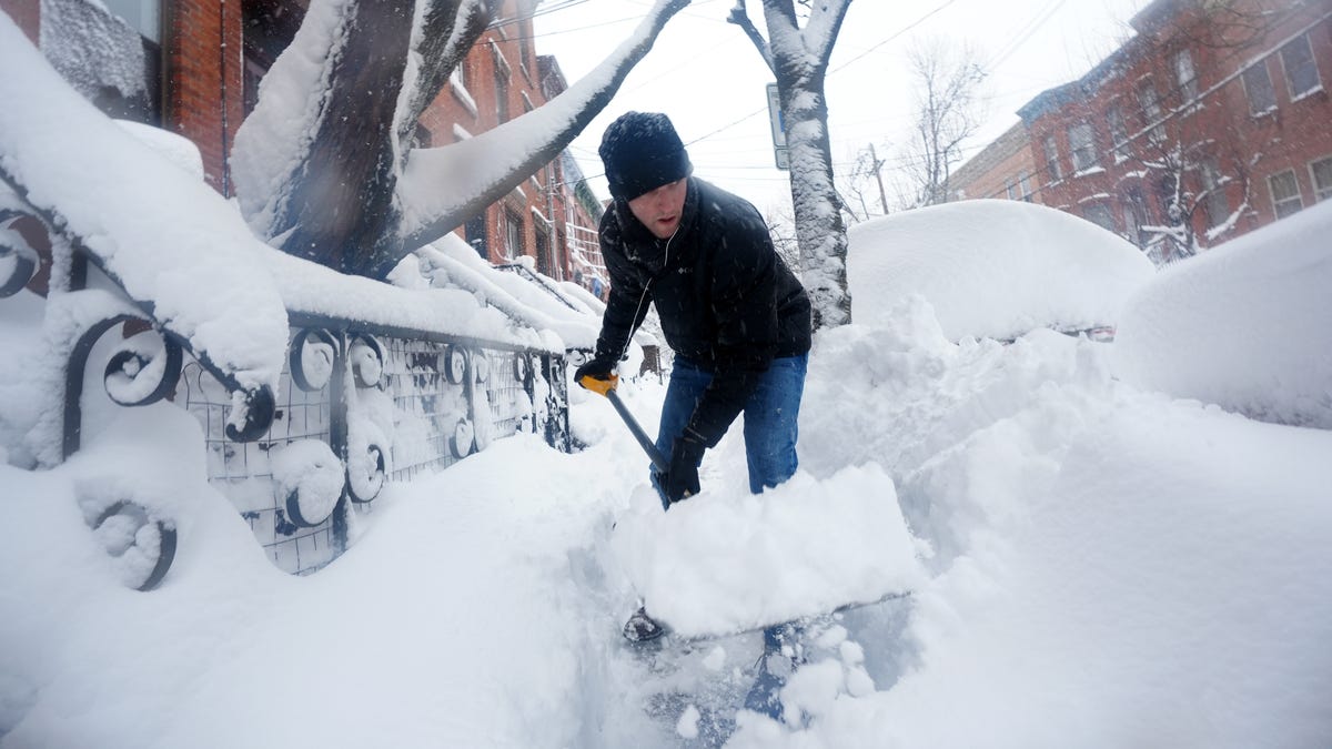 Snow up to your eyeballs! Photos show how deep the wintry blanket got