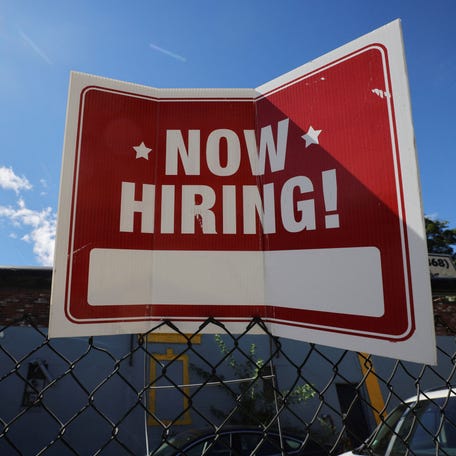 A "now hiring" sign is displayed outside Taylor Party and Equipment Rentals in Somerville, Massachusetts, U.S., September 1, 2022. REUTERS/Brian Snyder