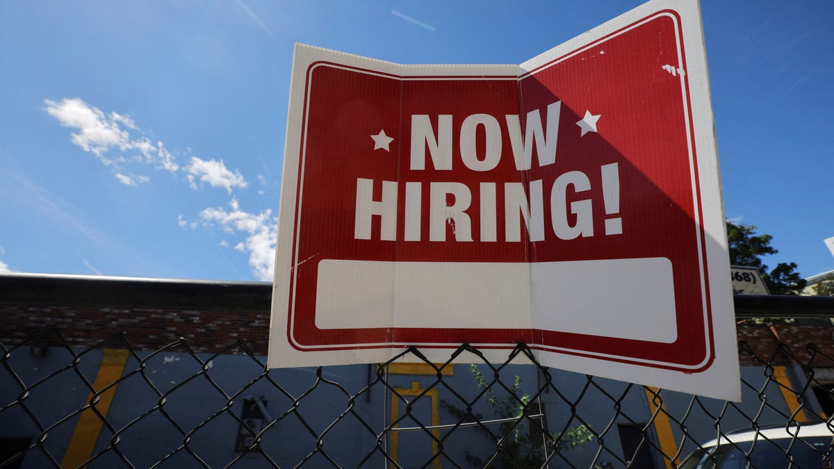 A "now hiring" sign is displayed outside Taylor Party and Equipment Rentals in Somerville, Massachusetts, U.S., September 1, 2022. REUTERS/Brian Snyder