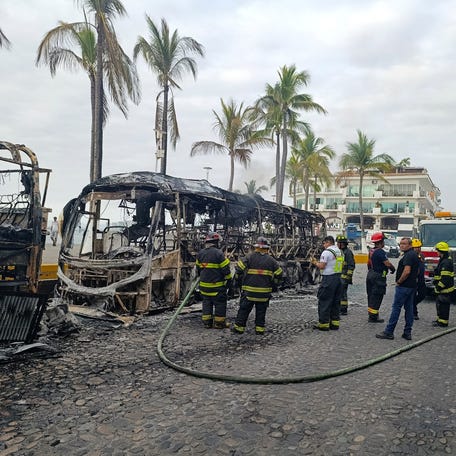 Firefighters work at the site where buses were set on fire by members of organized crime following a military operation in which Mexican officials said cartel boss Nemesio Oseguera, "El Mencho," was killed, at a tourist area, in Puerto Vallarta, Mexico, Feb. 22, 2026.