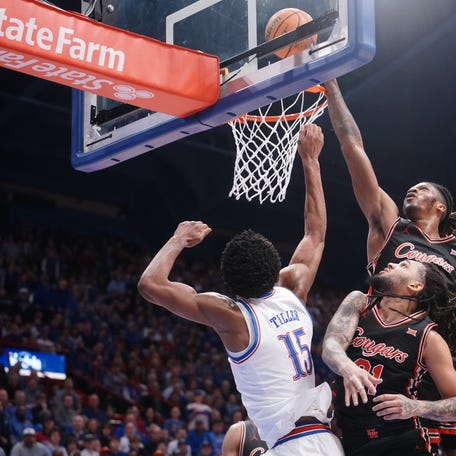 Houston Cougars forward Joseph Tugler (11) blocks a shot by Kansas Jayhawks forward Bryson Tiller (15) during the game inside Allen Fieldhouse on Monday, Feb. 23, 2026.