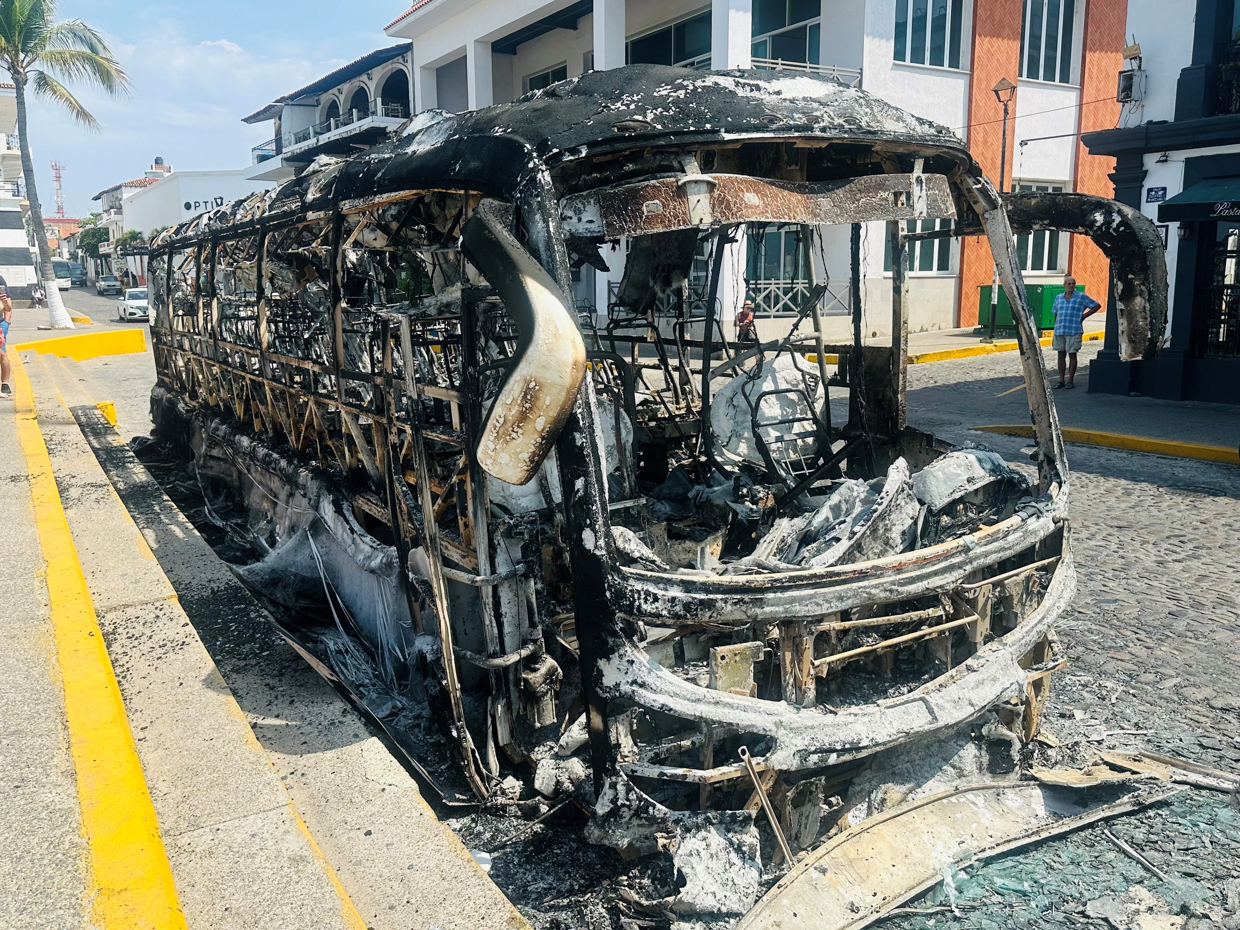 https://www.gannett-cdn.com/authoring/authoring-images/2026/02/24/PPHX/88834213007-a-closeup-look-at-a-burned-bus-seen-by-a-couple-caught-up-in-cartel-violence-in-puerto-vallarta-mexico-provided-by-pat-and-howard-fleischmann.jpg?auto=webp&crop=4031,2268,x0,y151&format=pjpg&width=1200