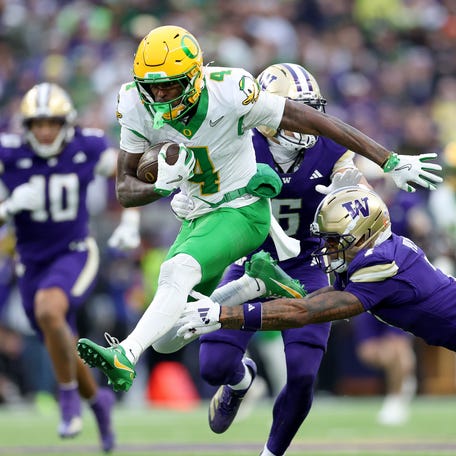 Malik Benson #4 of the Oregon Ducks escapes Ephesians Prysock #7 of the Washington Huskies during the second half at Husky Stadium on November 29, 2025 in Seattle, Washington.