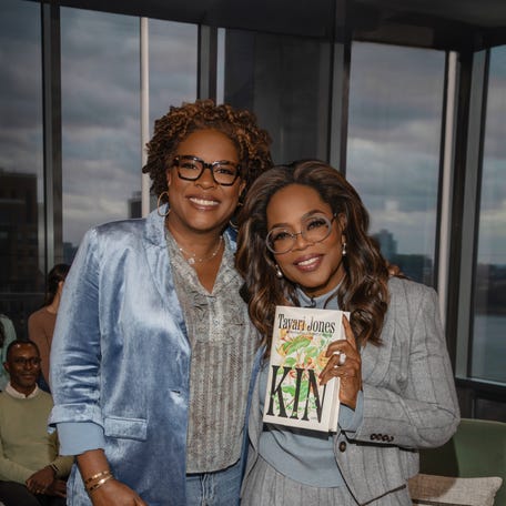Oprah Winfrey, right, holds a copy of "Kin" next to author Tayari Jones.