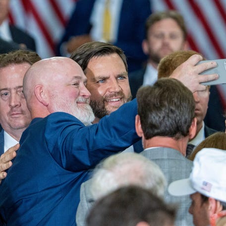 U.S. Rep Derrick Van Orden (R-WI), left, takes a selfie with Vice President JD Vance, right, after speaking at Mid-City Steel on Thursday August 28 in La Crosse, Wisconsin.