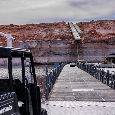 Low water levels in Lake Powell are apparent in this February 2026 image showing the end of a floating dock hanging off a cliff at Antelope Marina in Page, Arizona. Workers carved a new path to the water through the solid rock.
