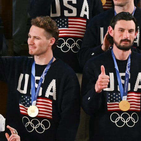 Goalie Connor Hellebuyck (R) gestures as members of the US Men's Olympic hockey team are recogized by US President Donald Trump as he delivers the State of the Union address in the House Chamber of the US Capitol in Washington, DC, on Feb.24, 2026.