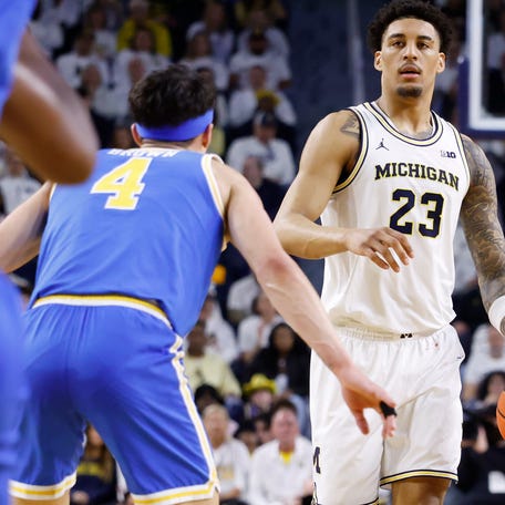 Feb 14, 2026; Ann Arbor, Michigan, USA; Michigan Wolverines forward Yaxel Lendeborg (23) is defended by UCLA Bruins guard Jamar Brown (4) in the first half at Crisler Center. Mandatory Credit: Rick Osentoski-Imagn Images