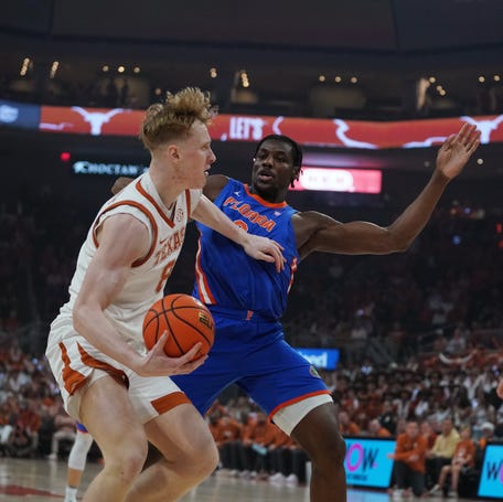 Texas Longhorns center Matas Vokietaitis looks to pass against Florida Gators center Rueben Chinyelu on Feb. 25, 2026, in Austin.
