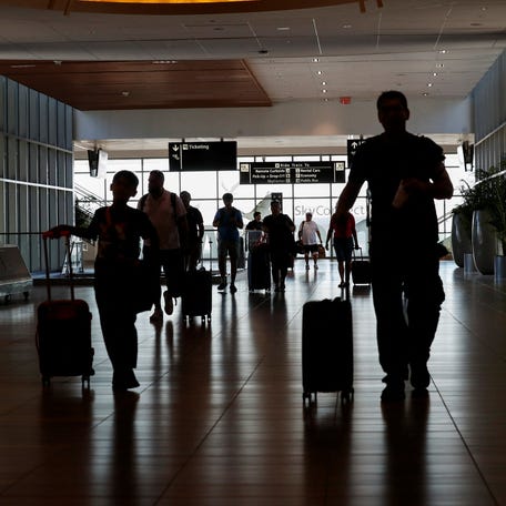 Passengers prepare to board flights at Tampa International Airport on July 19, 2024.