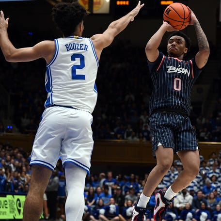 Nov 23, 2025; Durham, North Carolina, USA; Howard Bison guard Isaiah Brown (0) shoots over Duke Blue Devils guard Cayden Boozer (2) during the first half at Cameron Indoor Stadium. Mandatory Credit: Rob Kinnan-Imagn Images