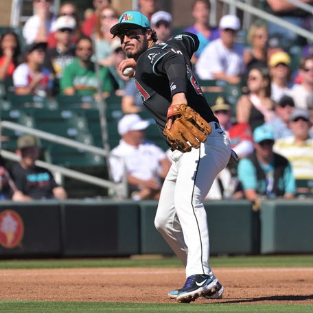 Arizona Diamondbacks third baseman Nolan Arenado gets Los Angeles Angels outfielder Jose Siri out at first in the third inning of their Feb. 22 spring training game.