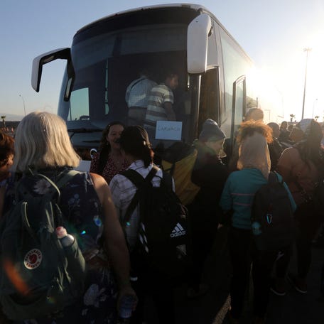 U.S. citizens board a bus at Limassol port on Oct. 17, 2023 after their evacuation from Haifa in Israel, amid conflict between Israel and the Palestinian Islamist group Hamas.