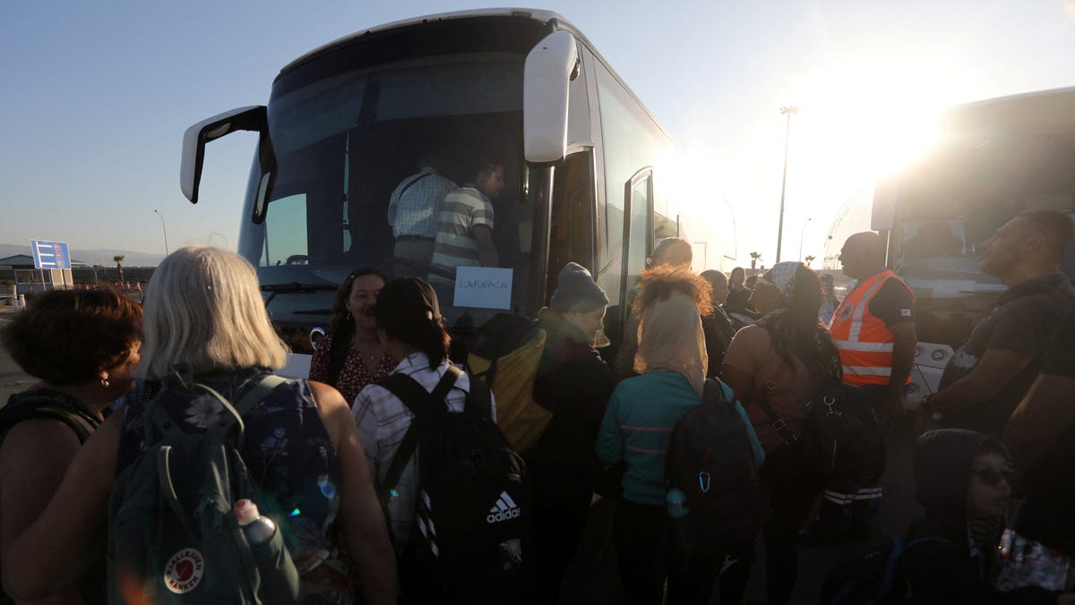 U.S. citizens board a bus at Limassol port on Oct. 17, 2023 after their evacuation from Haifa in Israel, amid conflict between Israel and the Palestinian Islamist group Hamas.