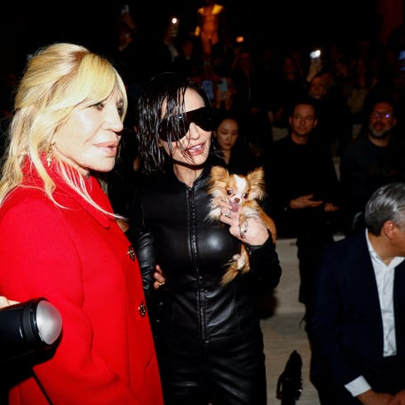Fashion designer Donatella Versace and Actor Demi Moore with her dog Pilaf pose ahead of a catwalk show for Gucci's fall/winter 2026/2027 collection during Milan Fashion Week, Feb. 27, 2026.