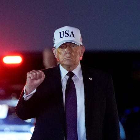 President Donald Trump pumps his fist after disembarking Air Force One at Palm Beach International Airport in West Palm Beach, Florida, U.S., February 27, 2026.