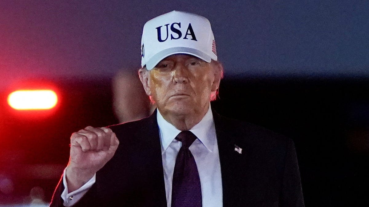 President Donald Trump pumps his fist after disembarking Air Force One at Palm Beach International Airport in West Palm Beach, Florida, U.S., February 27, 2026.