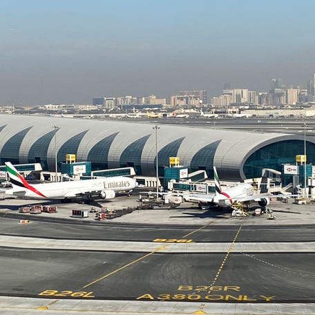 Emirates airliners are seen on the tarmac in a general view of Dubai International Airport in Dubai, United Arab Emirates January 13, 2021. Picture taken through a window.