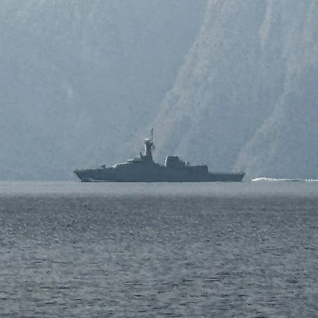 A navy vessel is seen sailing in the Strait of Hormuz, a vital waterway through which much of the world's oil and gas passes, on March 1, 2026.