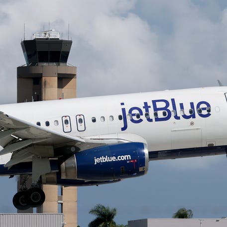 JetBlue Airlines plane lands near the Air Traffic Control tower at the Fort Lauderdale-Hollywood International Airport on October 07, 2025 in Fort Lauderdale, Florida.