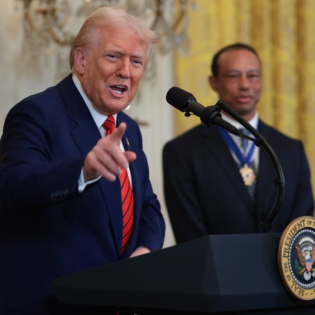 WASHINGTON, DC - FEBRUARY 20: U.S. President Donald Trump delivers remarks as Tiger Woods (R) looks on during a reception honoring Black History Month in the East Room of the White House on February 20, 2025 in Washington, DC. The Black History Month celebration comes as Trump has signed a series of executive orders ending federal diversity, equity and inclusion (DEI) programs and cutting funding to schools and Universities that do not cut DEI programs. (Photo by Win McNamee/Getty   Images)