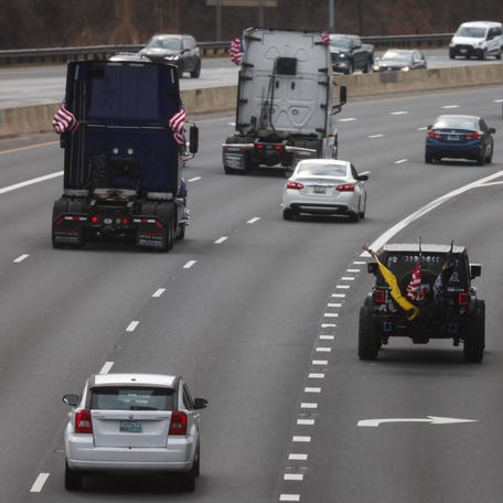 A convoy of trucks and other vehicles made up of protestors from several convoys of truckers and activists on various issues, including coronavirus disease (COVID-19) vaccine mandates, exit onto Interstate 495 to drive around the Washington beltway from Bethesda, Maryland, on March 6, 2022.