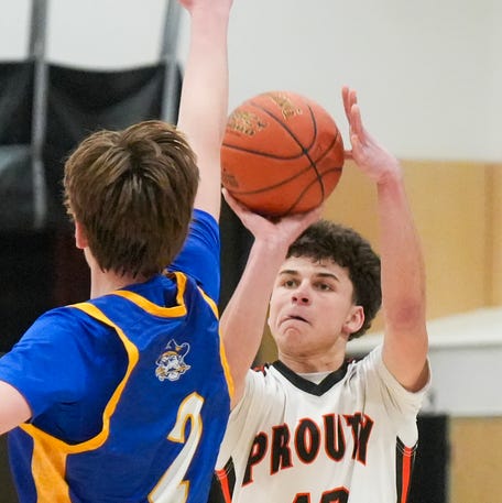 David Prouty’s Owen Granger shoots over Hull’s Liam Conneely during a playoff game onMarch 2 at David Prouty High School.