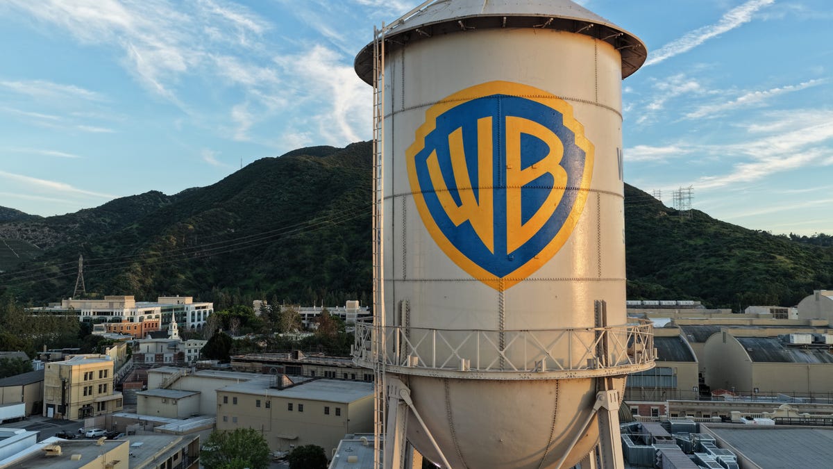In an aerial view, the Warner Bros. logo is displayed on the water tower at Warner Bros. Studio on February 27, 2026 in Burbank, California. Warner Bros. Discovery has agreed to be acquired by Paramount Skydance in a deal reportedly worth $110 billion.