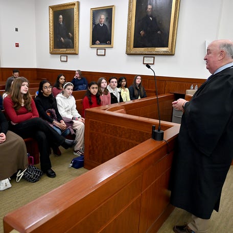 Maggie McShera's 8th grade civics class from Grafton Middle School listens to Superior Court Judge Daniel Wrenn after watching one of his sessions in courtroom 18.
