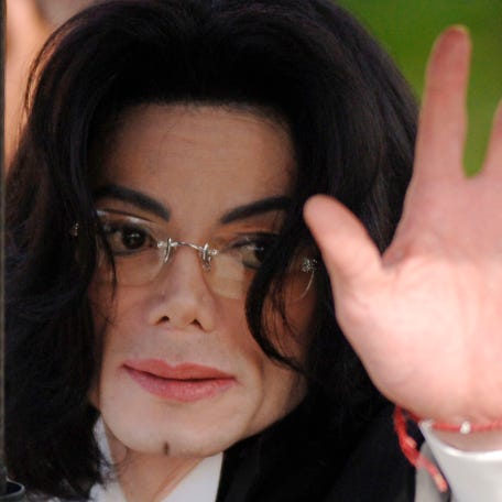 Michael Jackson waves as he arrives at the Santa Barbara County Courthouse in Santa Maria, California, on May 13, 2005.