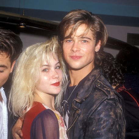 Christina Applegate and Brad Pitt pose at an Amnesty International event on Aug. 26, 1988.