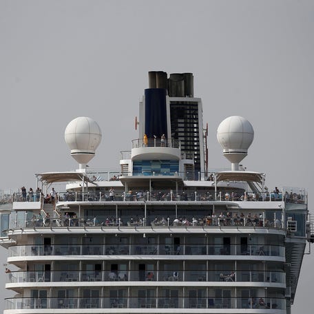 People stand on the deck of Mein Schiff 4 at the Piraeus cruise terminal, near Athens, Greece, Oct. 19, 2018.