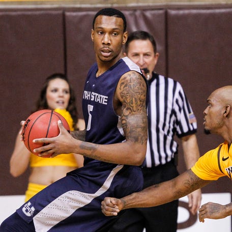 Utah State Aggies center Jarred Shaw (5) backs up against Wyoming Cowboys guard Jerron Granberry (15) during the first half at Arena-Auditorium in Laramie, Wyoming, on Feb. 1, 2014.