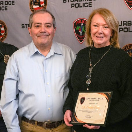 Dr. Christine Carey, right, received an award during an award ceremony March 4 in Sturbridge for helping save the life of Richard Paradise, left.
