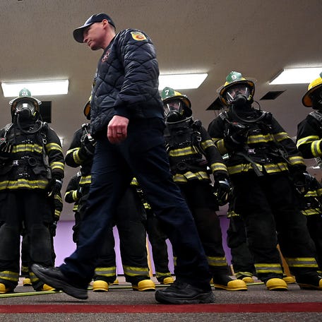 Lt. Philip Doherty walks back and forth in front of the line as a new recruit class prepares to walk the empty Denholm Building to learn about the aire supply lights and alarms.