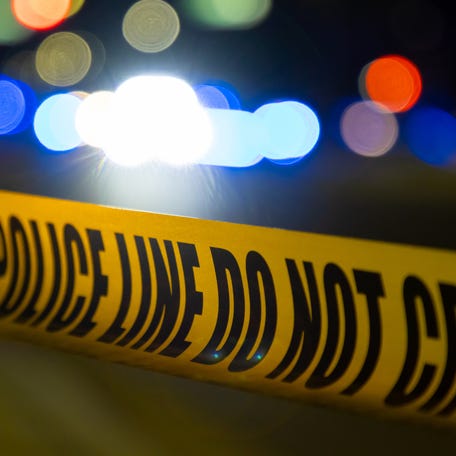 Police tape surrounds a crime scene.