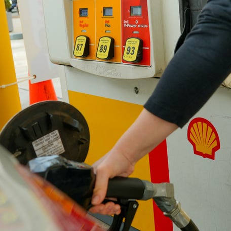 A woman pumps gas at a Shell station as the price of oil and gas has surged amid the U.S.-Israeli conflict with Iran, in Washington, D.C., U.S., March 5, 2026.