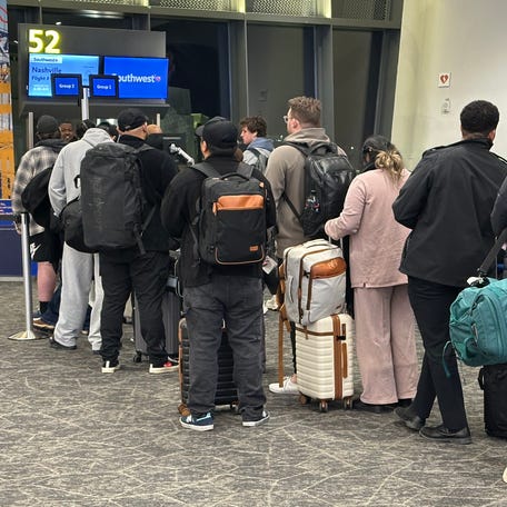 Passengers line up to board a Southwest Airlines flight on the carrier's first day of assigned seating.