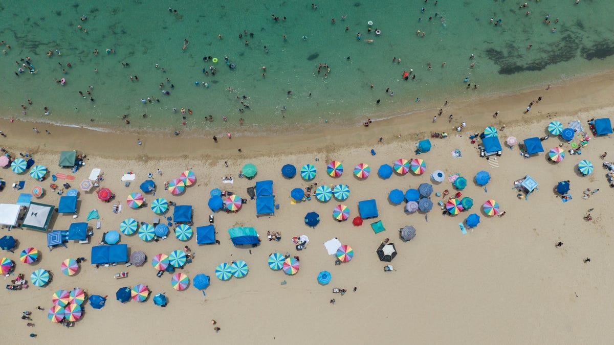 This aerial view shows people at the beach in Vega Baja, Puerto Rico, the municipality where Puerto Rican singer Bad Bunny grew up, on July 13, 2025.