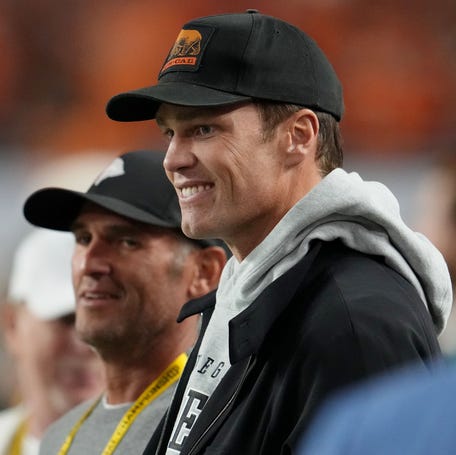 Tom Brady looks on from the sideline before the CFP National Championship college football game between the Indiana Hoosiers and the Miami Hurricanes at Hard Rock Stadium.