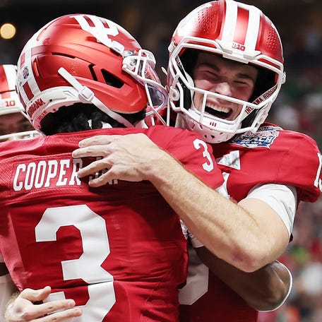ATLANTA, GEORGIA - JANUARY 09: Fernando Mendoza #15 of the Indiana Hoosiers celebrates with Omar Cooper Jr. #3 of the Indiana Hoosiers after a touchdown in the 2025 College Football Playoff Semifinal at the Chick-fil-A Peach Bowl at Mercedes-Benz Stadium on January 09, 2026 in Atlanta, Georgia. (Photo by Jonathan Bachman/Getty Images)