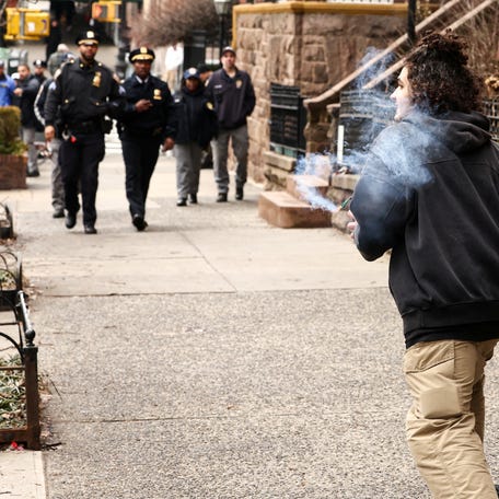 A person holds a suspicious device during a protest organized by Jake Lang in front of Gracie Mansion, New York Mayor Zohran Mamdani's official residence, in New York on March 7, 2026.