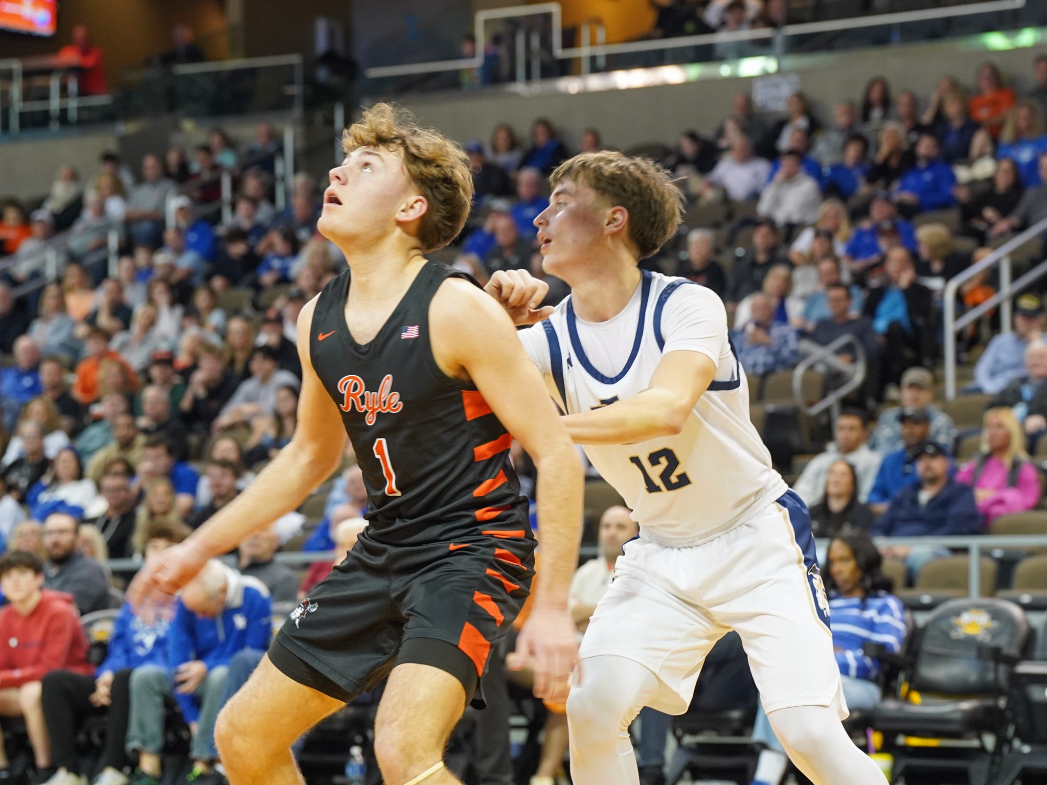 Ryle's Nathan Colemire (1) boxes out Lloyd Memorial's Colten Barger (12) during a Ninth Region semifinal game between the Raiders and Juggernauts on March 8, 2026.
