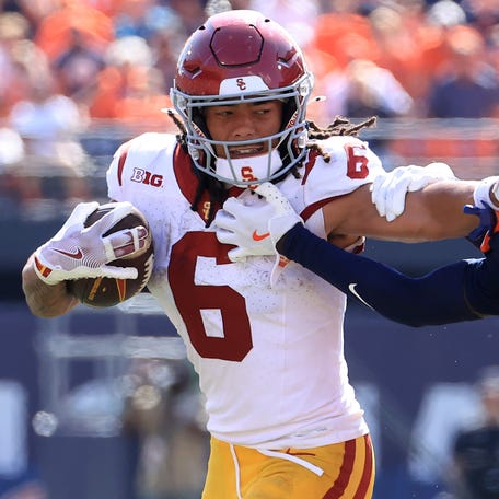 CHAMPAIGN, ILLINOIS - SEPTEMBER 27: Makai Lemon #6 of the USC Trojans stiff arms Jaheim Clarke #6 of the Illinois Fighting Illini at Memorial Stadium on September 27, 2025 in Champaign, Illinois. (Photo by Justin Casterline/Getty Images)