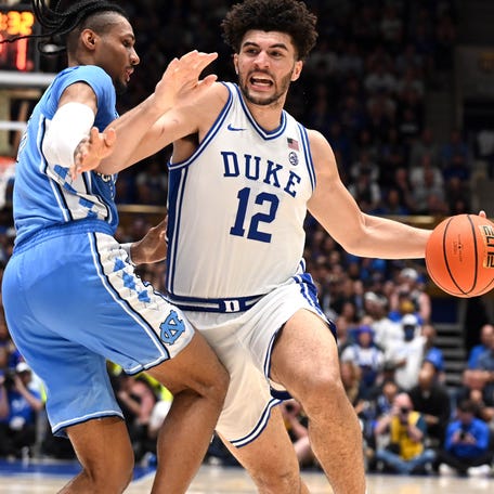 Duke forward Cameron Boozer (12) drives to the basket as North Carolina forward Jarin Stevenson (15) defends during their game at Cameron Indoor Stadium.